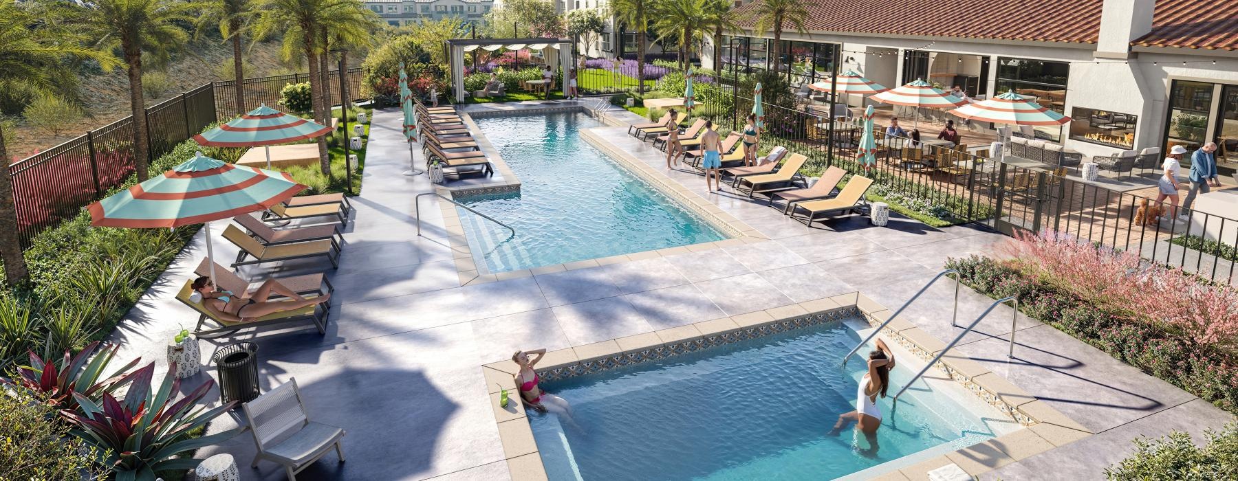 a swimming pool with lounge chairs and umbrellas next to a building