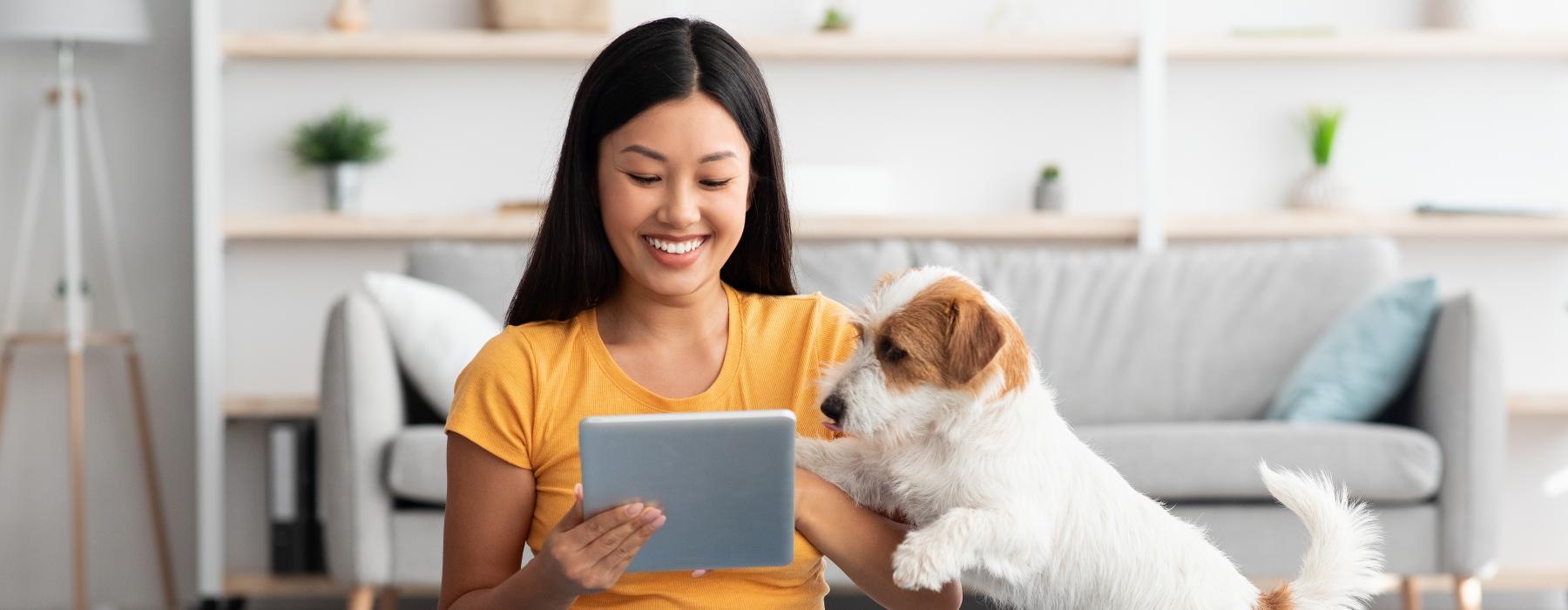 a woman sitting on the floor with a dog