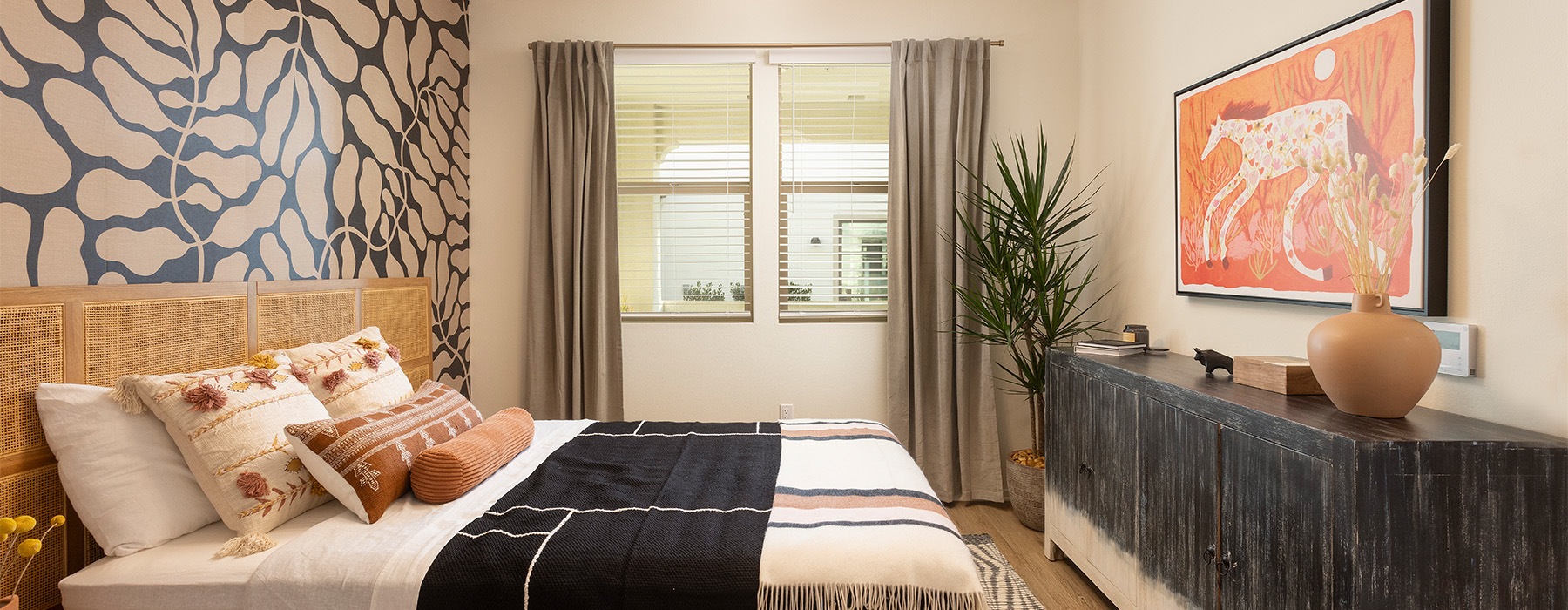 A bed in a bedroom with wall art