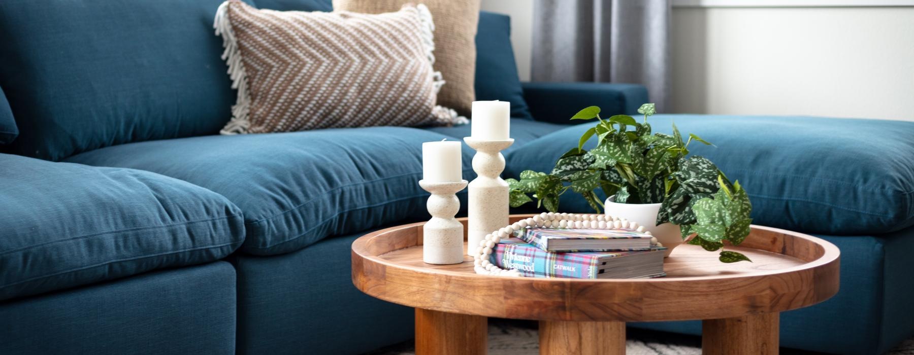 a blue couch with a coffee table and a coffee table